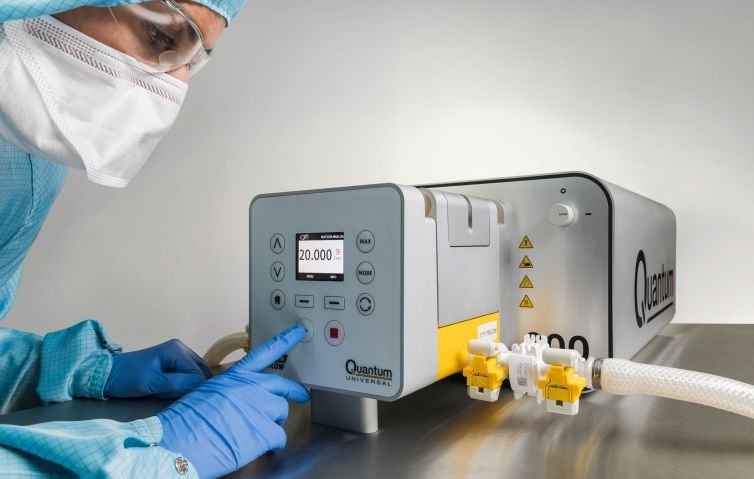 A woman in. a laboratory uses an industrial pump photographed in a studio by a product photographer in cornwall.