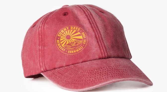 A faded red baseball cap on a white background.