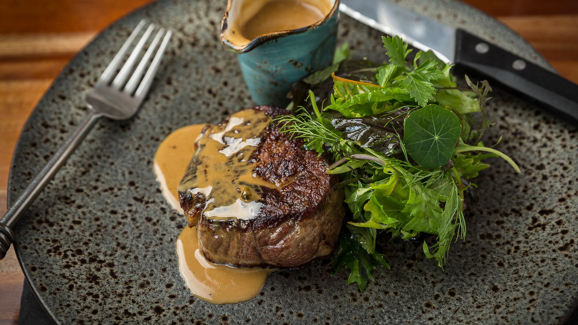 Steak with a rich sauce expertly captured by a food photographer in Cornwall.